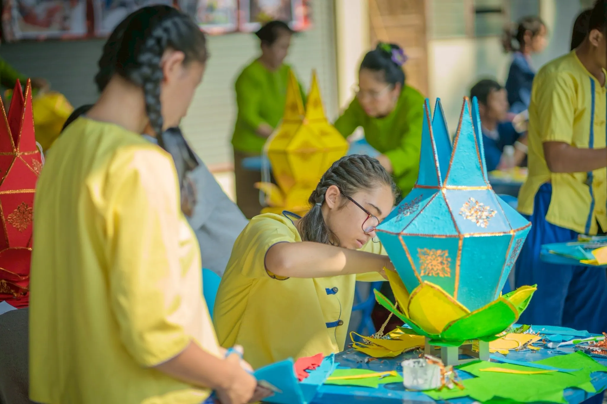 Young children creating festive paper lanterns