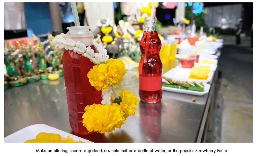 Different types of offerings to spirit houses, including the popular red Fanta.