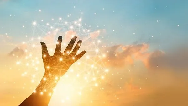 An artistic image of a person's hands reaching out to the sky with a high-tech network.