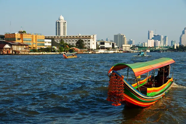 Colorful Chao Phraya Express boats run by Saphan Taksin BTS Station.