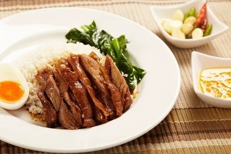 Khao kha moo or pork leg over rice from the Bib Gourmand Michelin-starred street food in Bangkok.