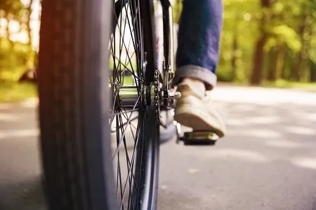 A shot of someone's feet peddling a bicycle.