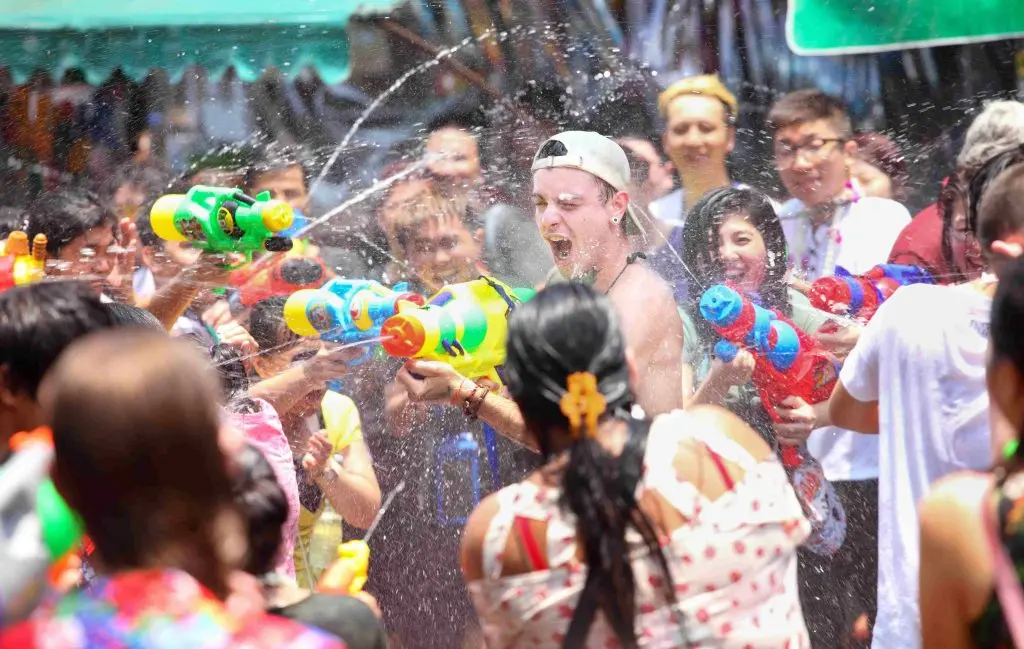 People splashing each other with water to celebrate the Songkran festival (Thai New Year).