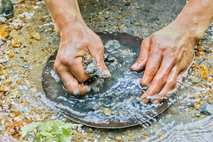 A person gold panning.