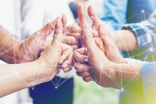 A collection of people's thumbs facing each other with a technological visualization surrounding them.
