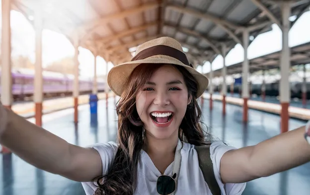 A Thai lady smiling as she is taking a selfie.