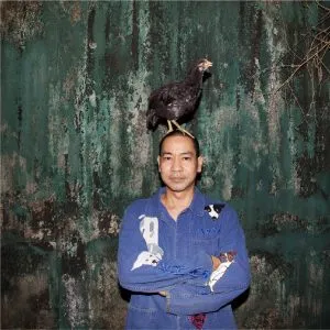 Jakkai Siributr, one of the leading textile artists of Southeast Asia, with a chicken on his head.