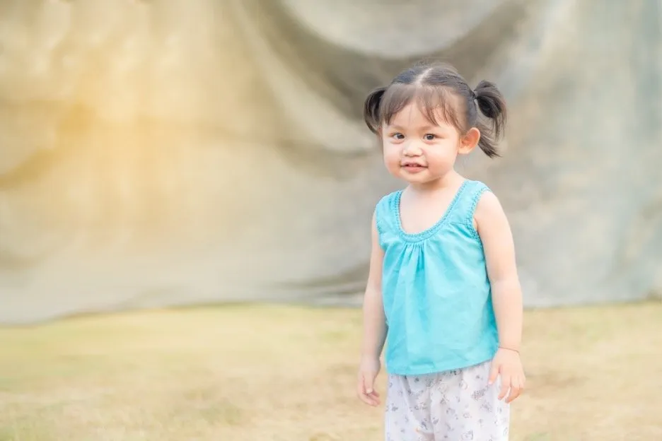 A child wearing suea kor krachao, a traditional sleeveless top garment.