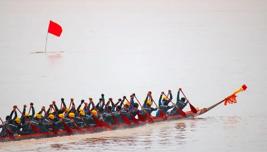 Rowing crew competing in a longboat race at Nakhon Pathom, Thailand.