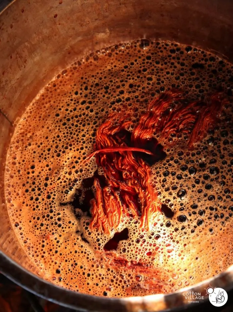 Boiling padauk dye vat.