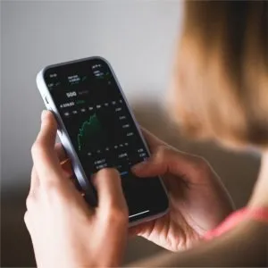 A person checking the stock market on mobile phone
