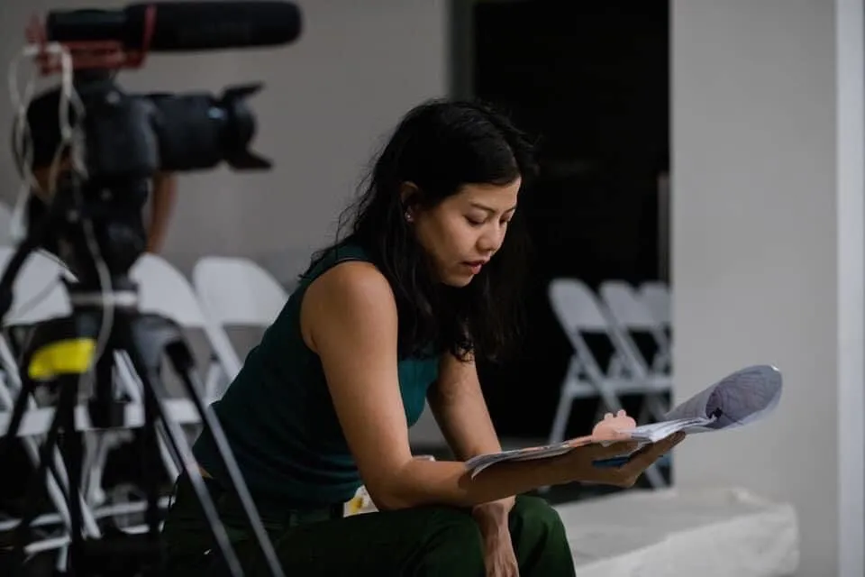 Bua Anuman Rajadhon reading a script before the final performance at Contemporary Art Museum.