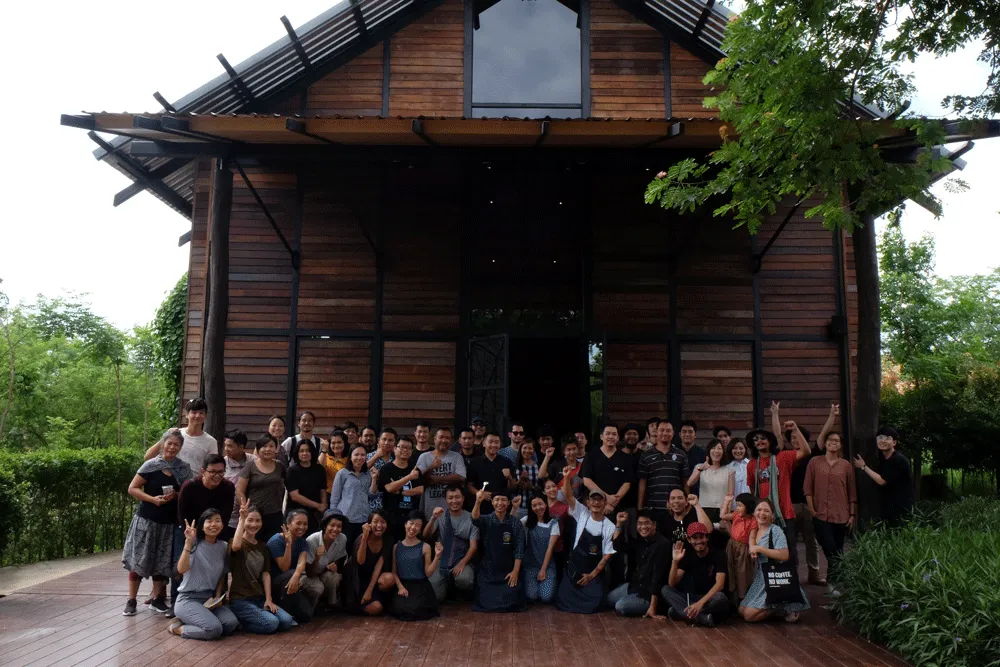 A group of visitors in front of Akha Ama Living Factory.