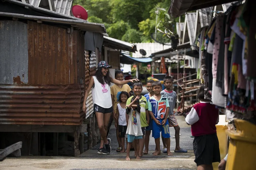 Tourists interacting with Moken children in the village