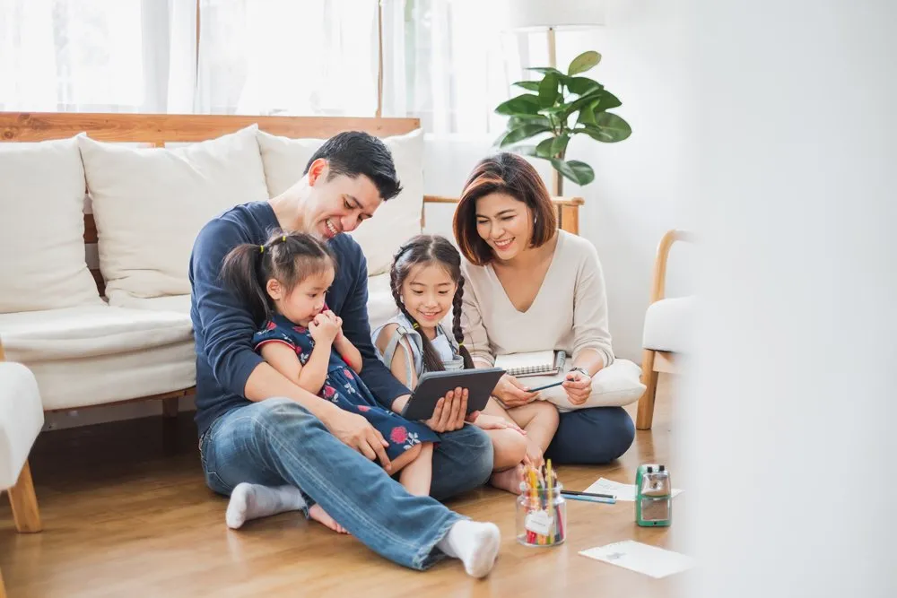Parents with two kids enjoying their time at home together