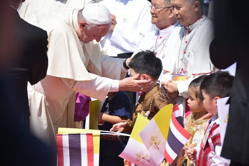 Pope Francis greeting a child during his visit to Thailand.