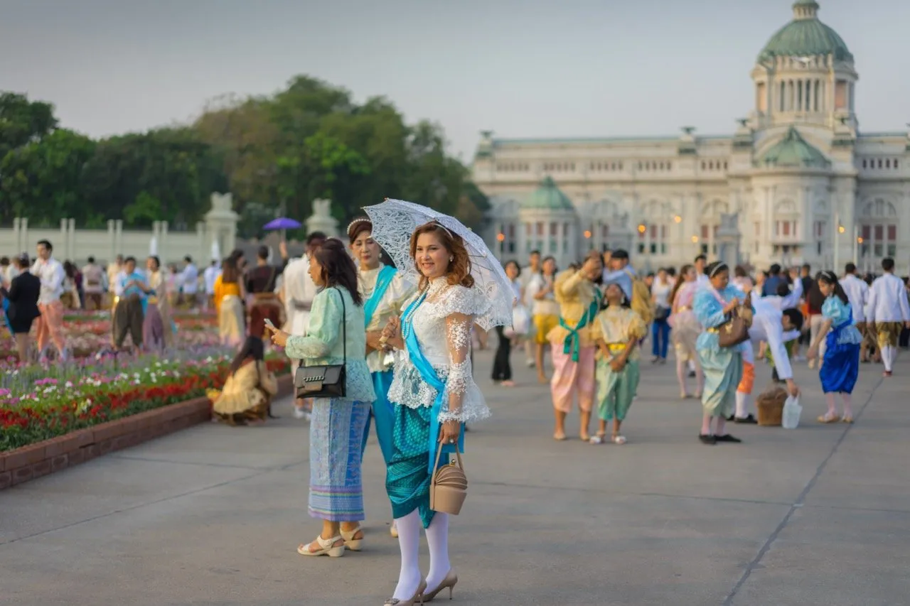 Thai woman in a Thai traditional dress with an umbrella in front of Ananta Samakhom Throne Hall in Bangkok, Thailand