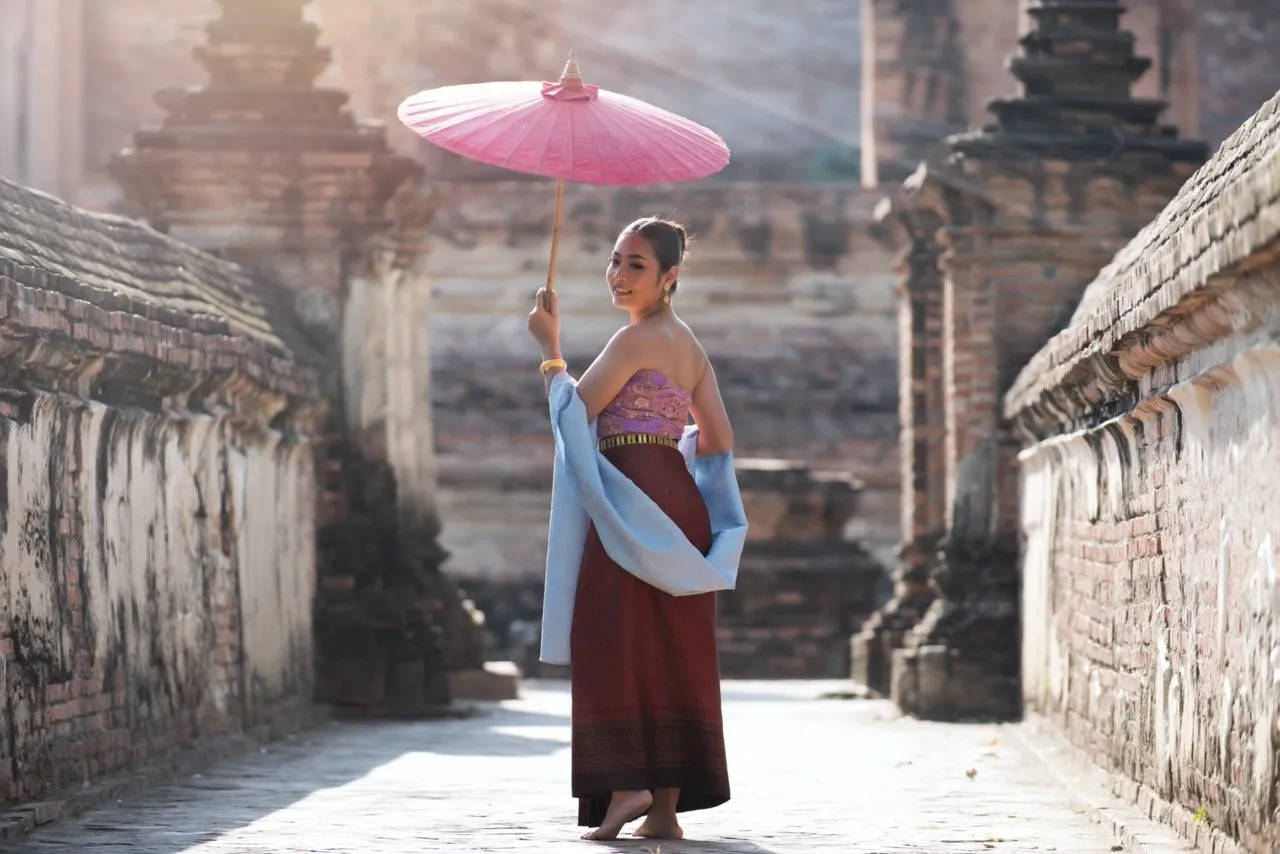 A woman in a traditional Thai outfit