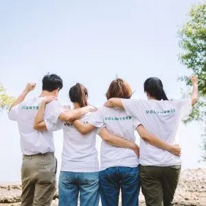 A group of volunteers with their arms around each other