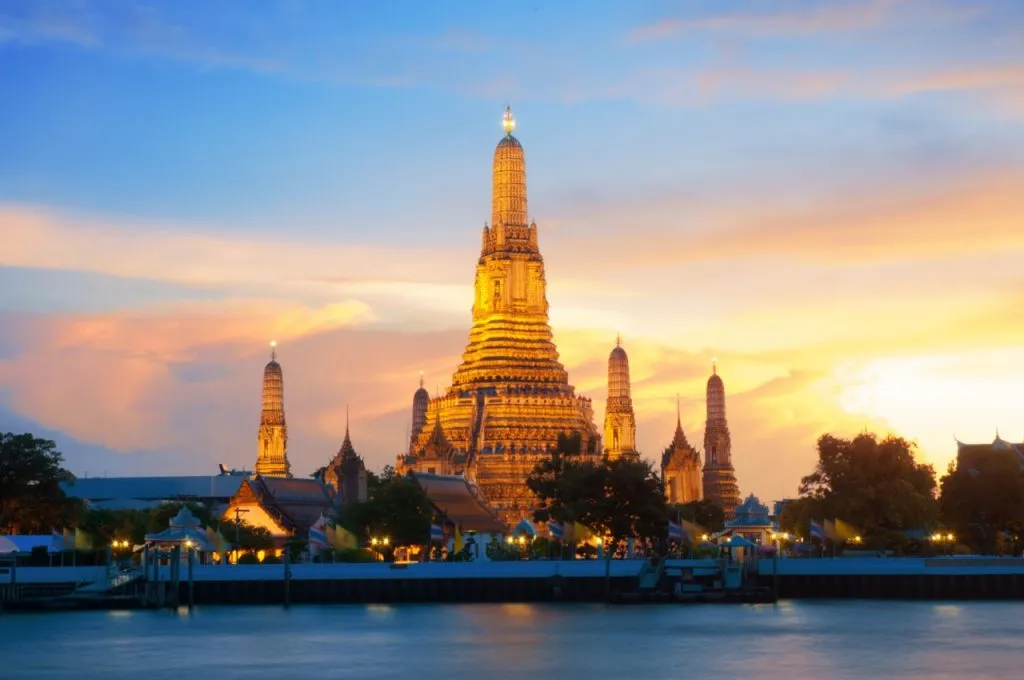 Wat Arun Temple during sunset on Chao Phraya River, Bangkok, Thailand