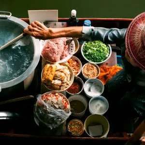 Boat noodle vendor on a floating boat