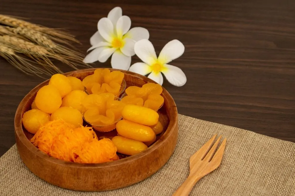 A Thai traditional dessert, Foi Thong, and other similar Thai traditional desserts served in a bowl