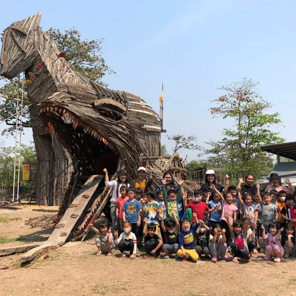 Kids playing and posing in front of the playground area at Get Growing Community Farm