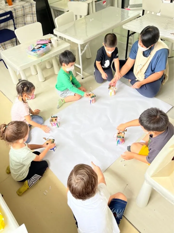 Kids creating an art piece as part of the learning program at Playville