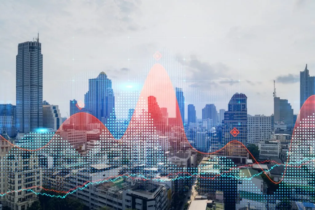 A hologram of a stock market chart over a panoramic cityscape of Bangkok