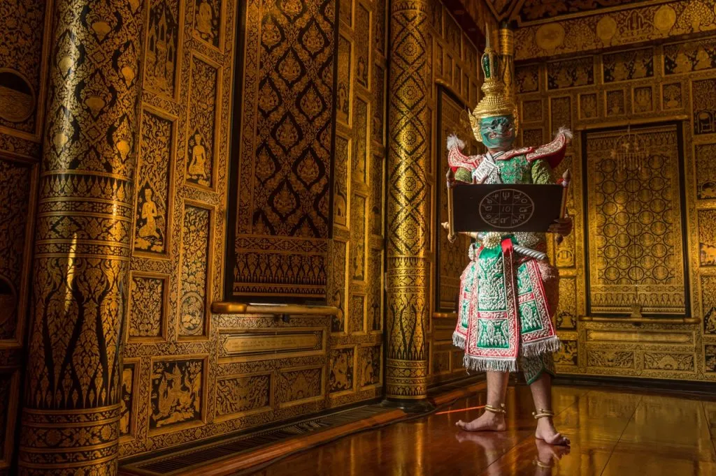 A Thai dancer dressed ready to perform the Khon with a traditional scroll in his hands.