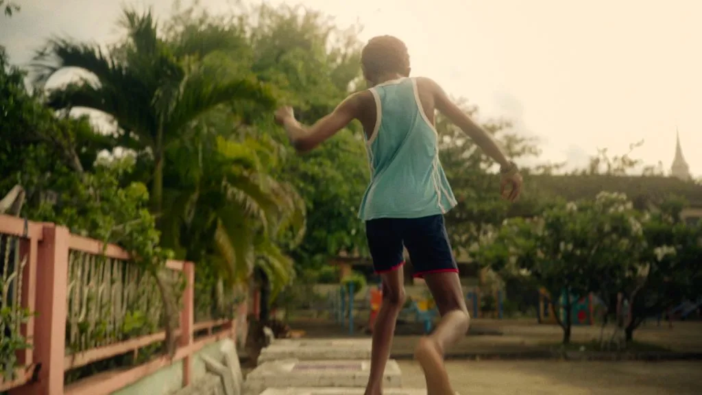 A scene of a boy from the Hours of Ours, Komtouch's documentary, is a feature-length documentary that depicts the trials and tribulations of a Sudanese family stranded in Thailand.