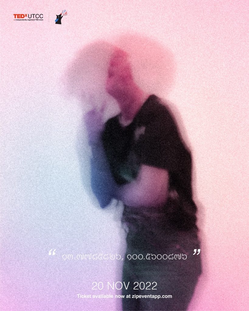 An out of focus picture of the fourth speaker with the hint of "13.7785826" and "100.5600876"