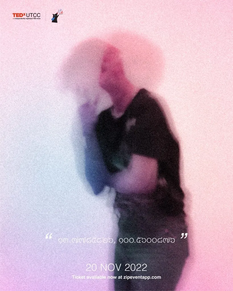 An out of focus picture of the fourth speaker with the hint of "13.7785826" and "100.5600876"
