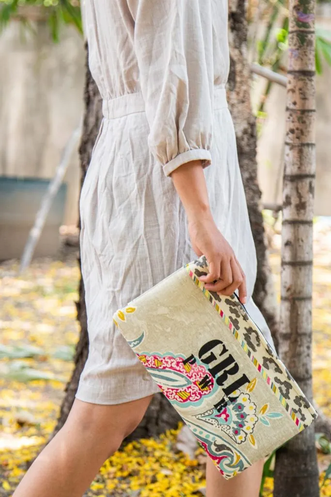 A person holding a Girl Power clutch bag by Dao Ethical Gifts