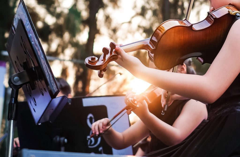 Two people playing violins