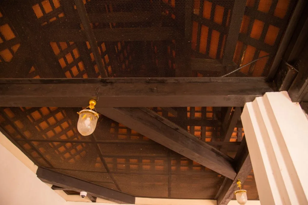 Diagonal wood beam put in place through joinery of covered gallery, Wat Phutthaisawan