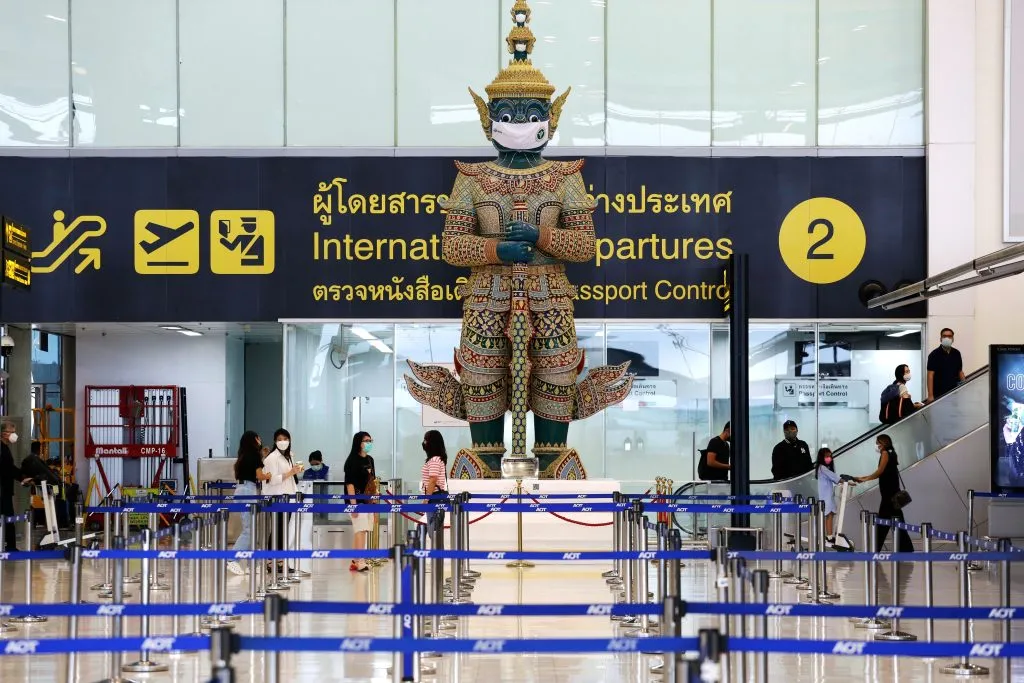 A Hindu Ramayana giant statue dons a face mask to remind passengers to keep COVID-19 precautions in Suvarnabhumi international airport (BKK)