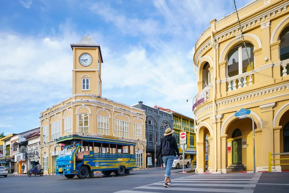 Woman walking on crosswalk in old quarter of Phuket.