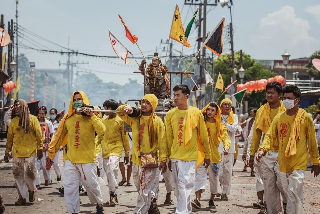 The crowds of Chinese Taoism devotees and worshipers participating in street procession at Phuket old town of the traditional Phuket Vegetarian Festival.