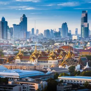 The Golden Grand Palace of Bangkok in the foreground and the skyscraper view of cityscrape in the background