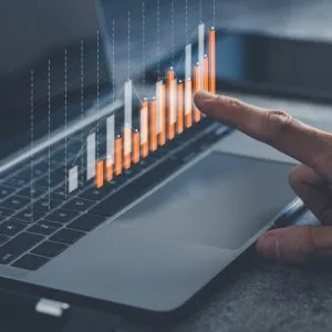 A laptop with a chart representing growth and success