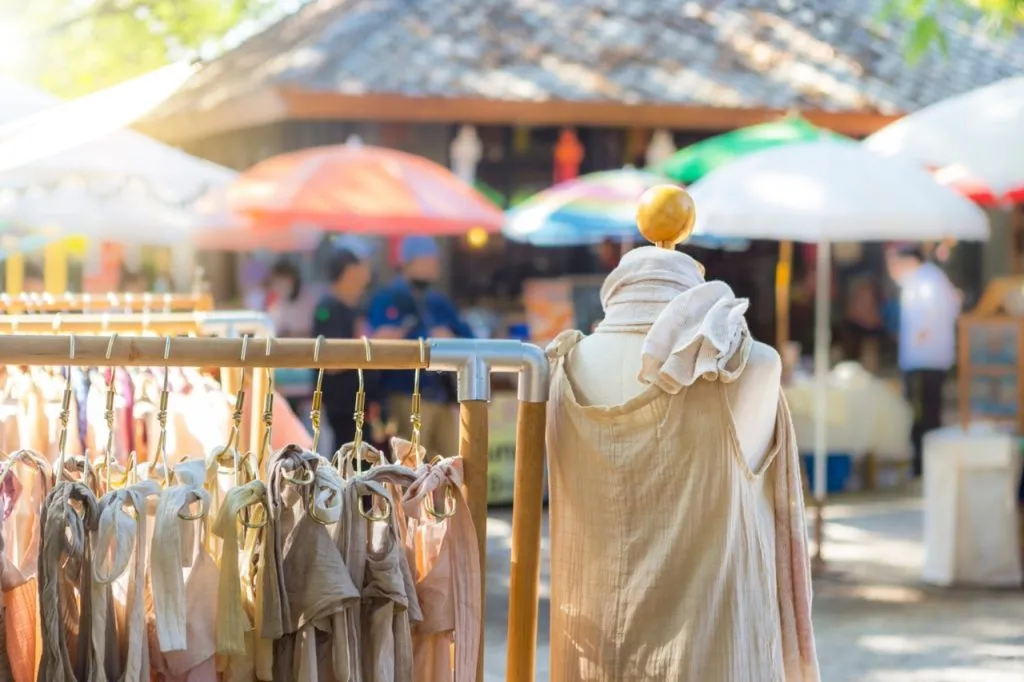 A clothing store with natural color cutton clothes at an outdoor market