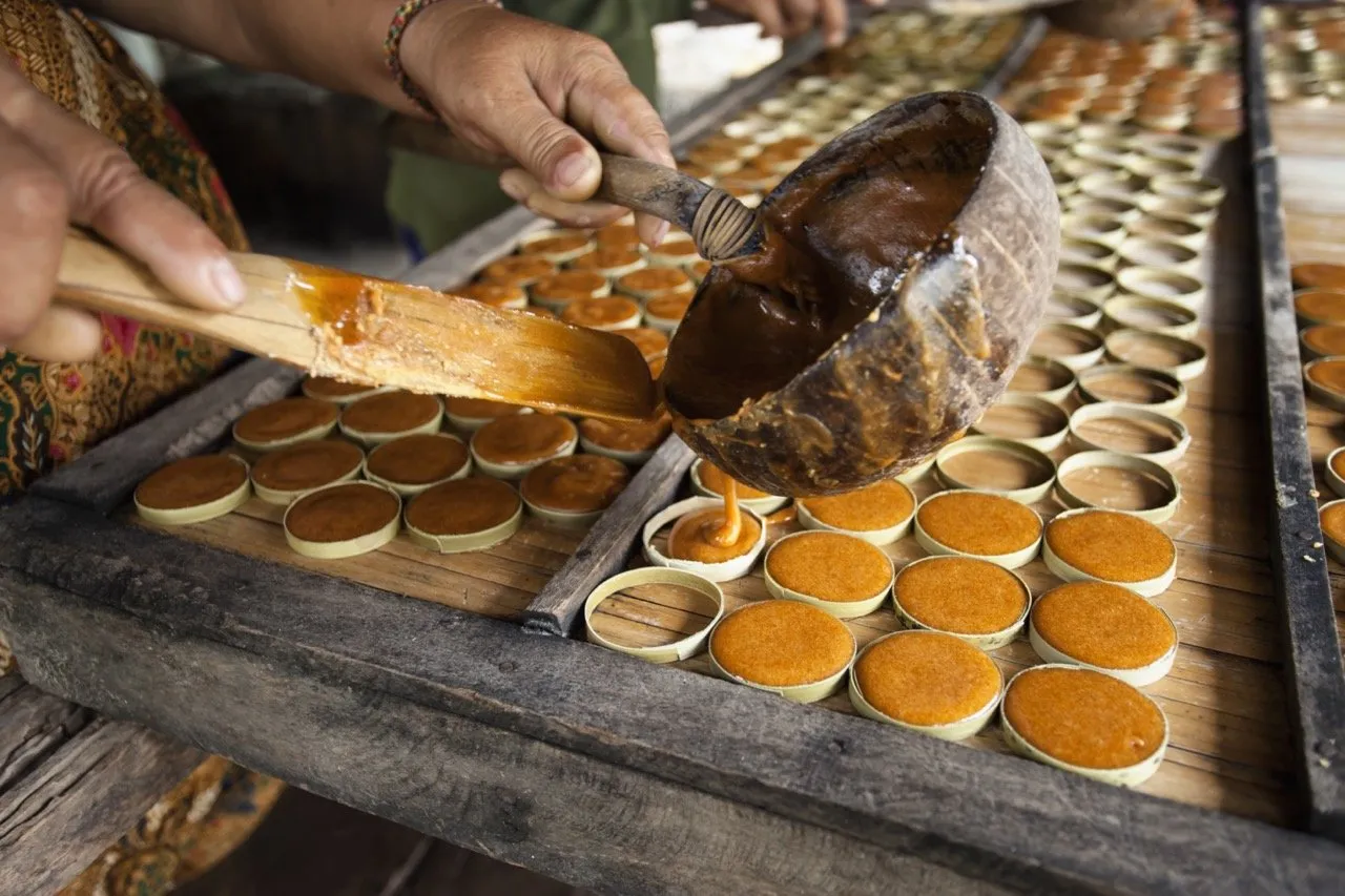 Palm sugar being poured into a mold
