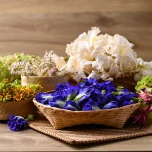 Colorful edible Thai flowers in different baskets