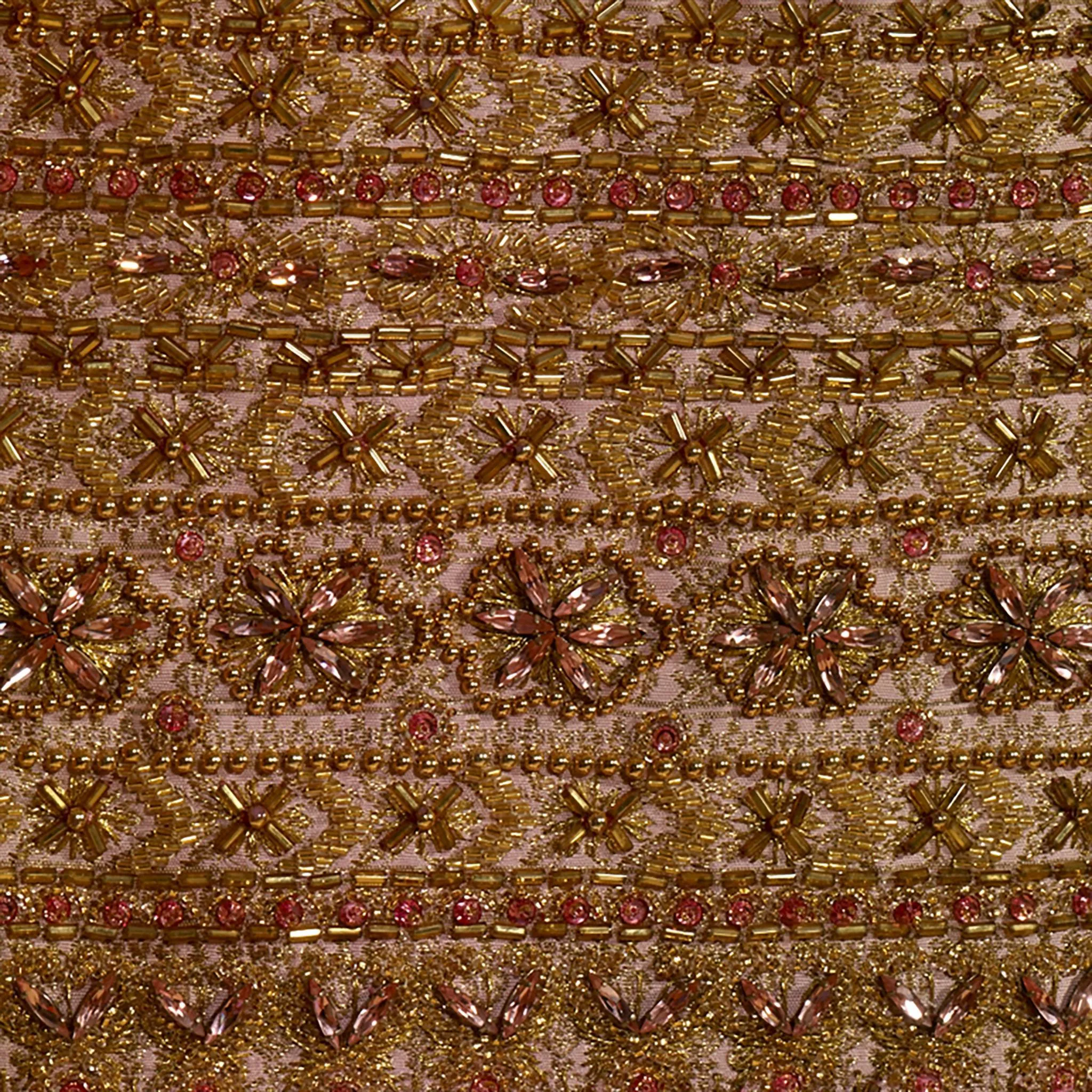 A close-up shot of the Boromphiman dress, highlighting small pink ornaments arranged to form flower shapes