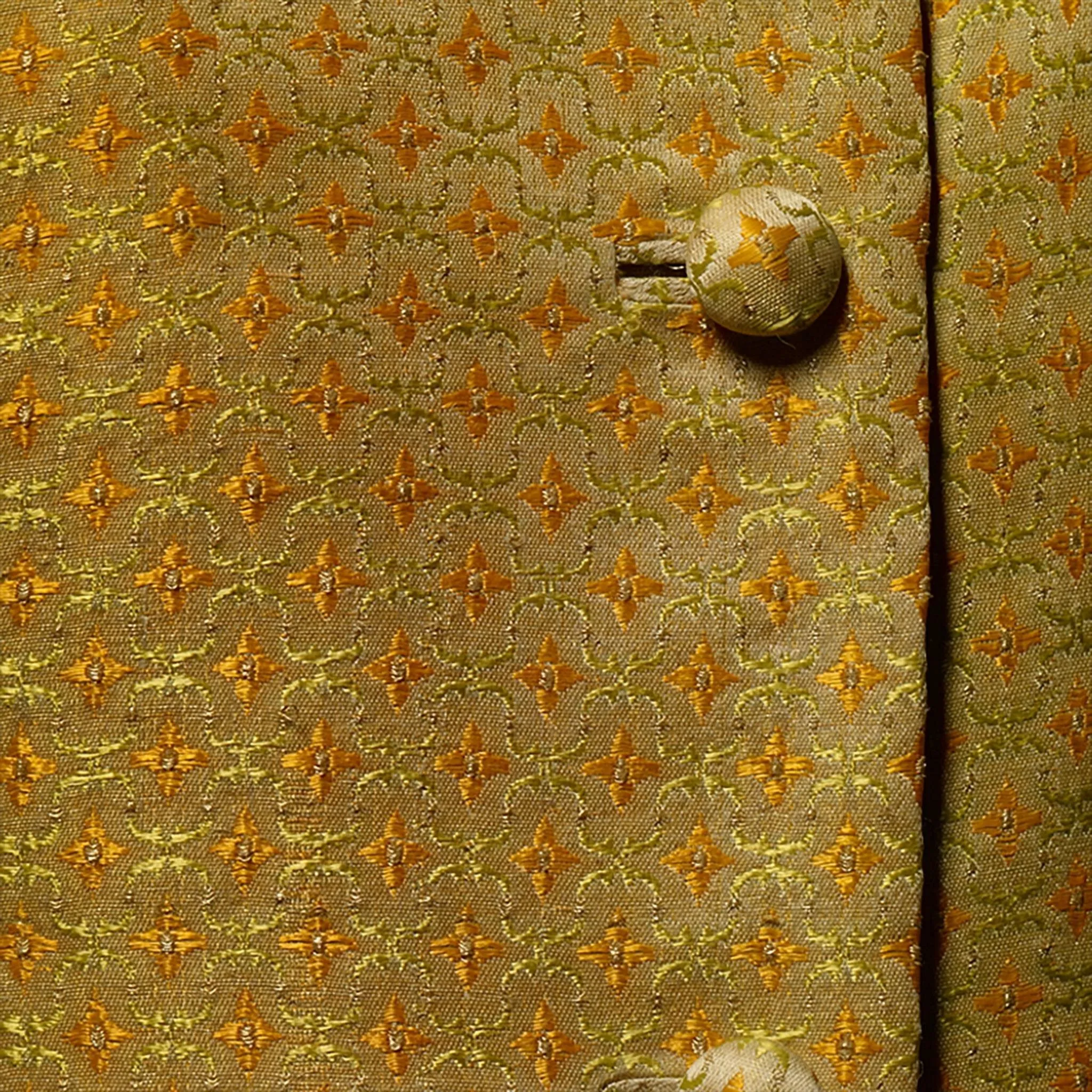Closer inspection of the Chitralada traditional Thai dress reveals an ornate pattern that repeats throughout the entire fabric of the matching blouse and skirt. 