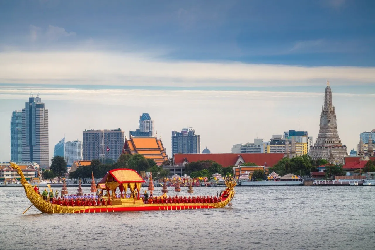 A photo of Royal Barge Procession in the past in front of Wat Arun