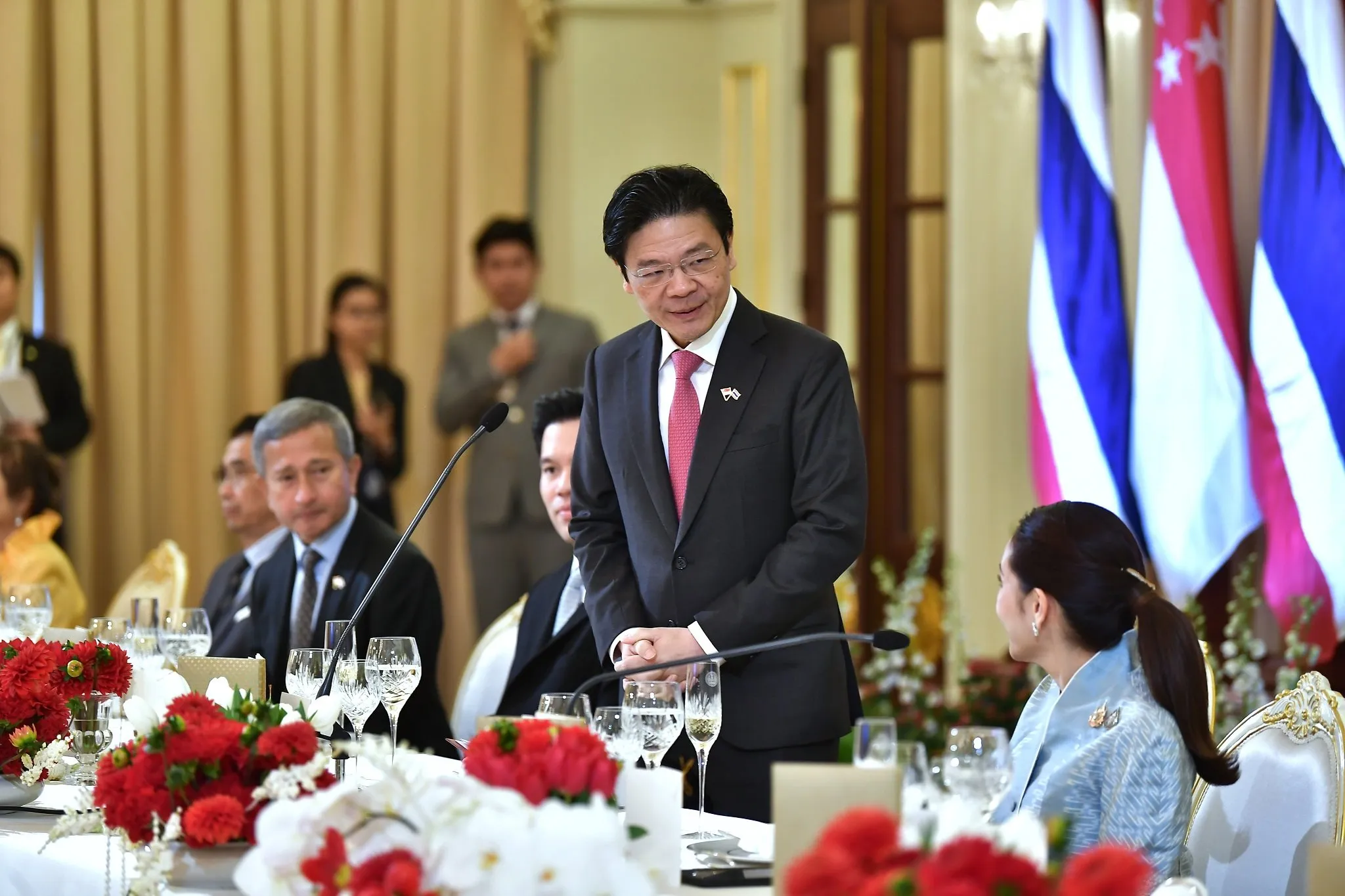 Singapore Prime Minister Lawrence Wong (left) speaking at an official luncheon hosted by Prime Minister Paetongtarn Shinawatra (right)