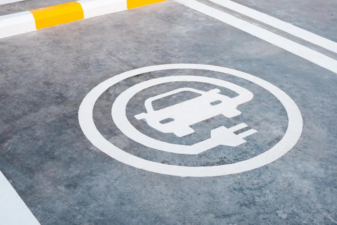 EV or electric car charging sign painted on the ground of parking lot