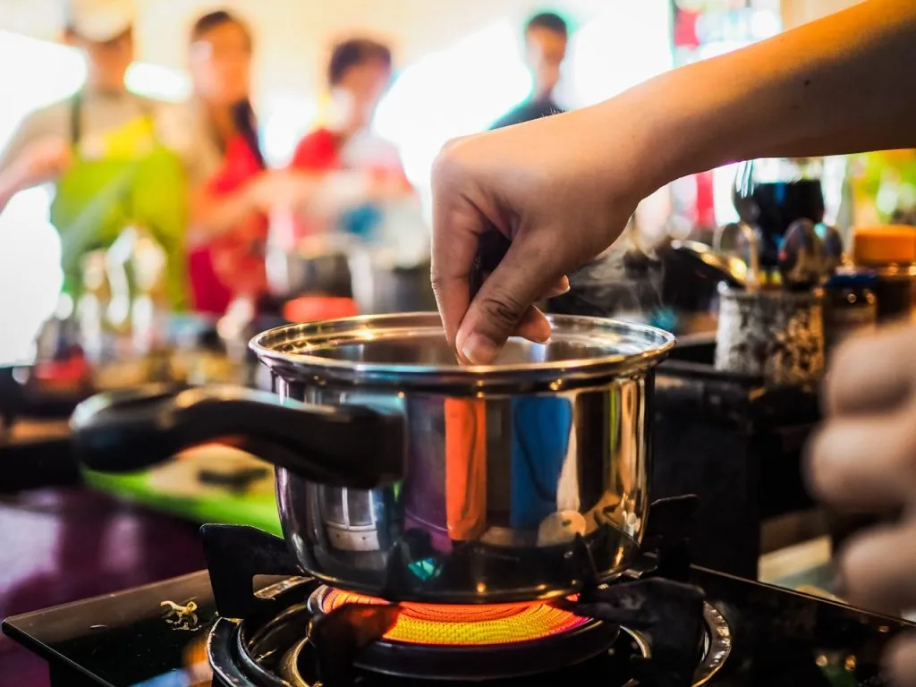 A closeup shot of a pot on a gas stove